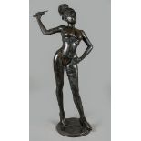 A life-size bronze sculpture of a mistress wielding the whi