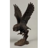 A bronze sculpture of an attacking little owl. Second half