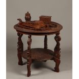 A richly carved smoking set consisting of a table, a cigare