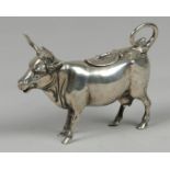 A silver creamer in the shape of a cow, marked "Z" and "800