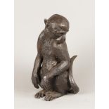 A drak patinated bronze statue of a monkey. H.: 32 cm.