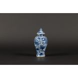 A porcelain baluster-shaped lidded vase with rich floral de