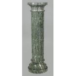 A dark green marble column.