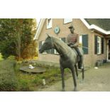 A life-size bronze garden statue of an officer on horseback