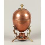 A red copper egg warmer with burner. ca 1900. H.: 27,5 cm.