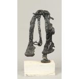 A dark patinated abstract bronze on a white marble base. 2n