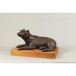 A brown patinated bronze of a dog on a wooden base. 2nd hal