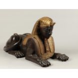 A gold and brown patinated bronze sculpture of a sphynx, se