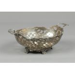 A silver bonbon basket, openworked and engraved with flower