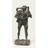 A bronze sculpture depicting a man reading the newspaper. s