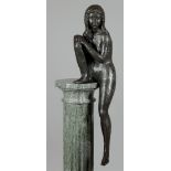 A bronze pool statue of a seated nude, indistinctly marked