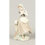 A porcelain sculpture depicting a girl feeding pigeons, mar