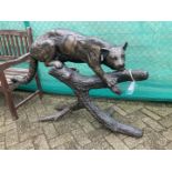 A dark patinated bronze of a cat-like on a tree stump. Seco