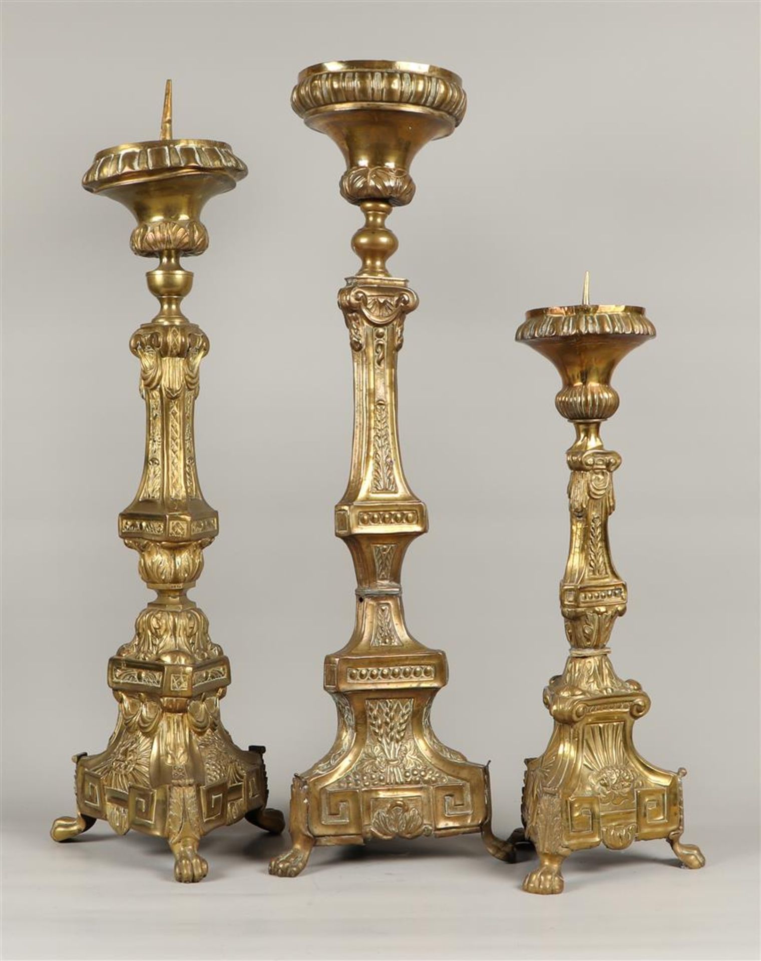 A lot consisting of (3) copper altar candlesticks.19th cent