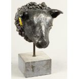 A bronze sheep's head on a hard stone pedestal. 2nd half of