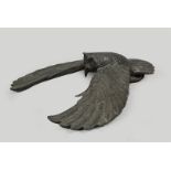 A bronze sculpture of a low-flying owl striking prey. Secon