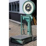 A very large Toledo industrial scale on cast iron wheels. H