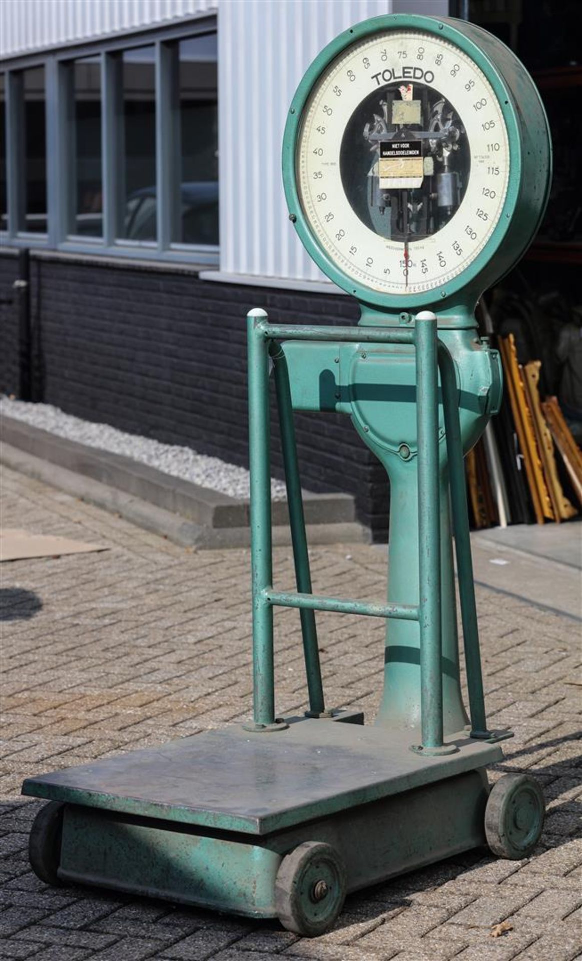 A very large Toledo industrial scale on cast iron wheels.
H