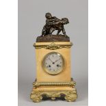 A yellow marble mantel clock with bronze ornaments, on top