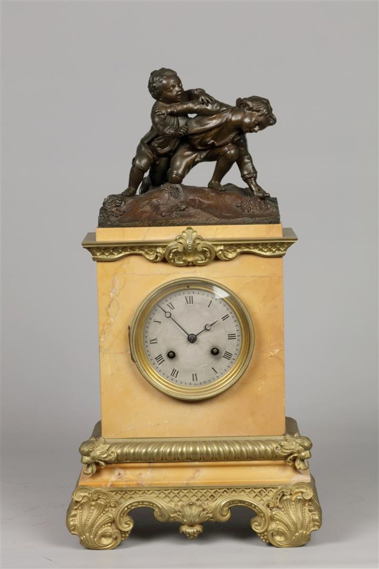A yellow marble mantel clock with bronze ornaments, on top 