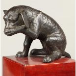 A dark patinated bronze of a puppy. H.: 24 x L.: 40 cm.