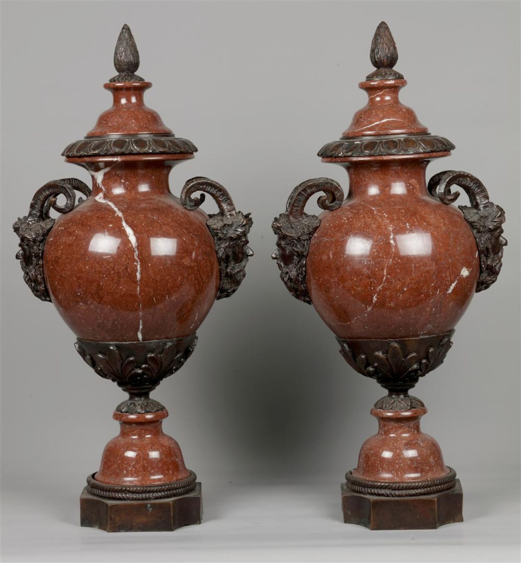 A pair of monumental red marble casolettes on a bronze base