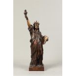 A bronze sculpture in the shape of the statue of liberty. 2