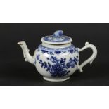 A porcelain teapot with floral decor and fruit-shaped handl