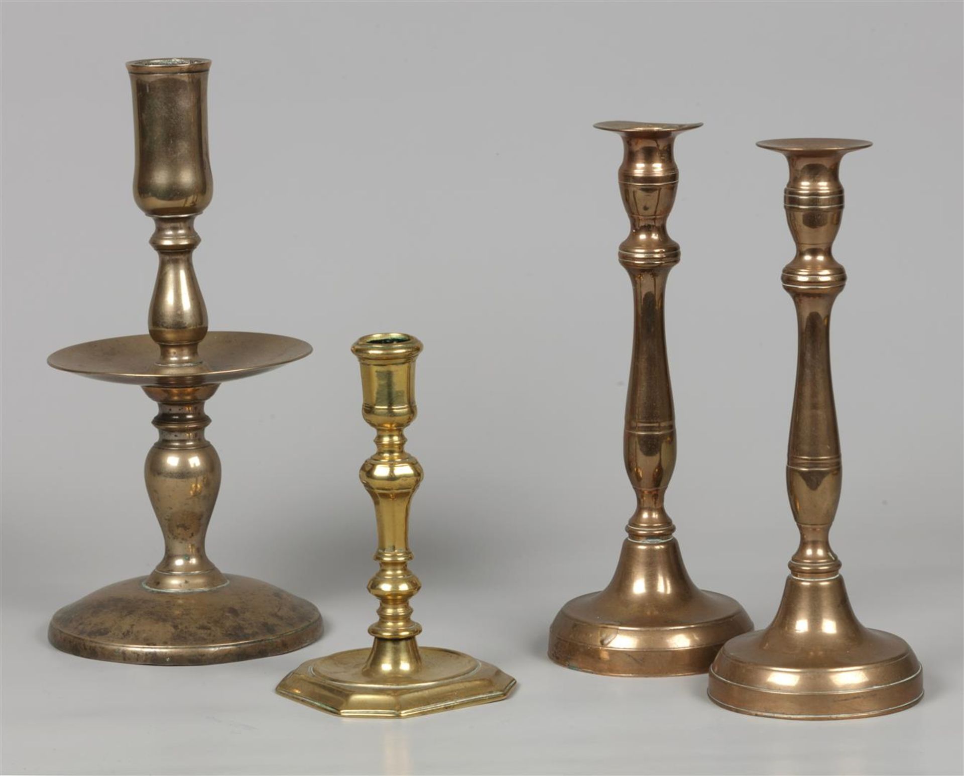 A lot consisting of (4) candlesticks, including a disc cand