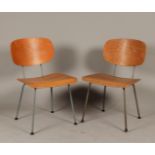 Two mid-century modern lounge chairs with curved plywood se