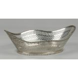 A large silver openworked bread basket with and soldered pe