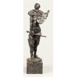 A bronze sculpture of a clown playing the violin. 2nd half