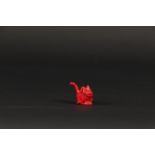 A miniature sculpture of a dog in red coral. 1st half of th