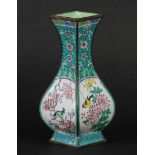 A 4-pass-shaped enamelled baluster vase with flower beds an