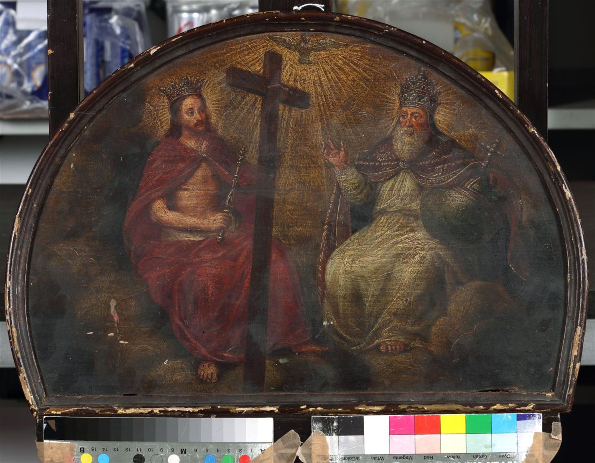 A convolute of three religious paintings depicting a crucif