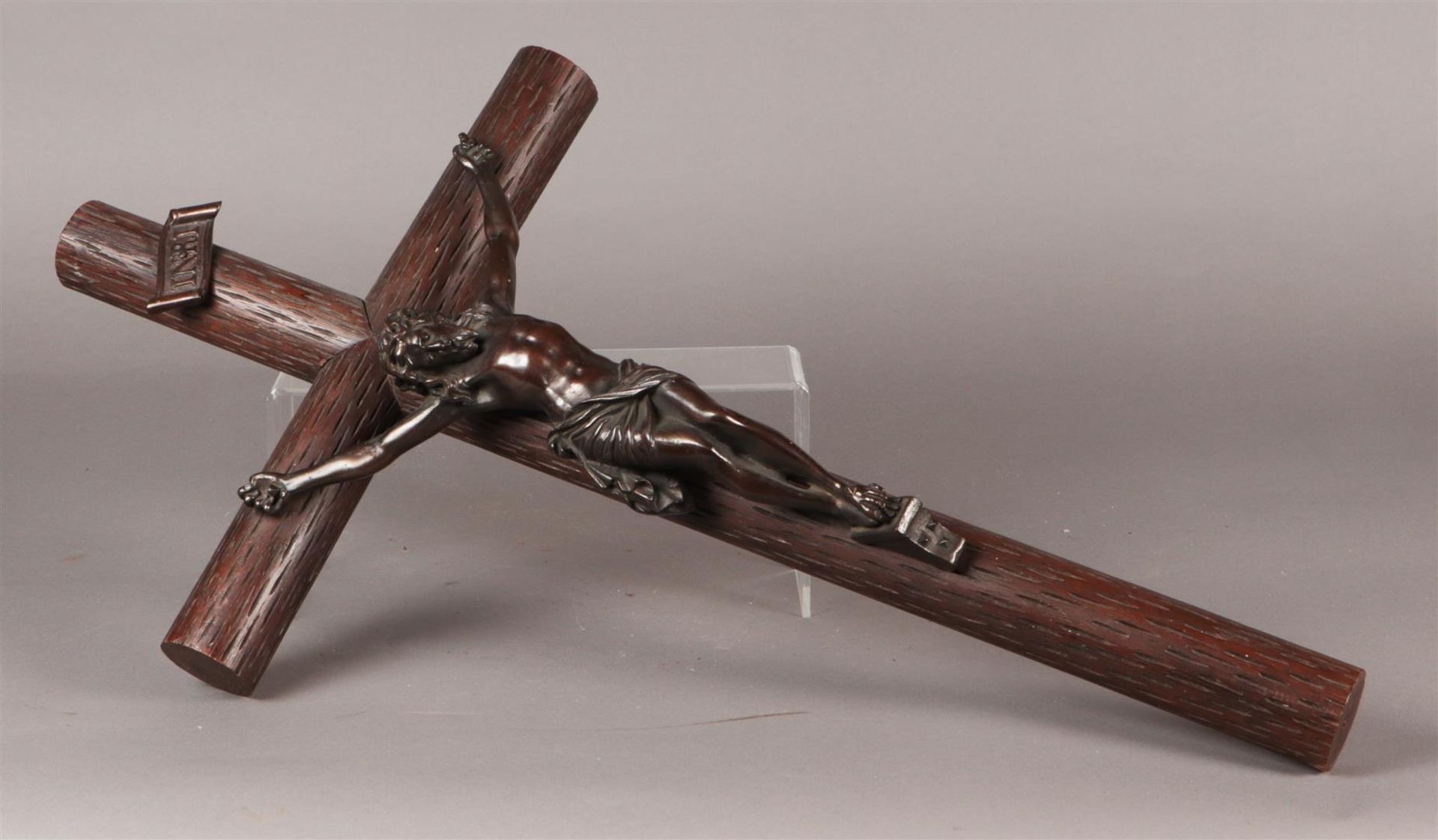 A large crucifix with cast bronze Christ mounted on a carve