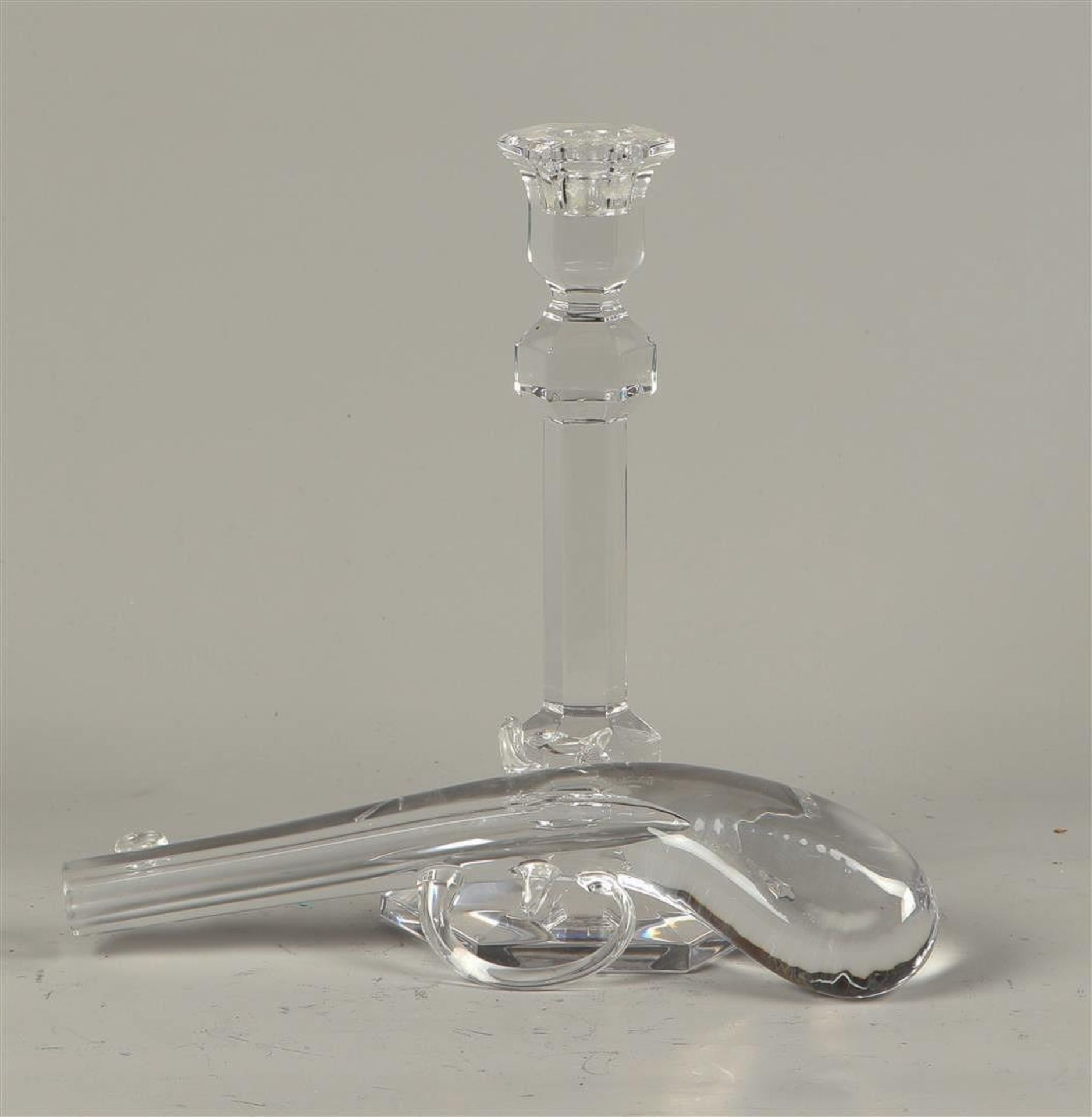 A lot consisting of a glass candlestick and revolver in glass, both marked Val Saint Lambert. Belgiu