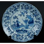 A porcelain plate with a tulip outer rim with floral decor and butterflies. The center with two long