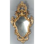 A gilded cut wooden Louis XV wall mirror.