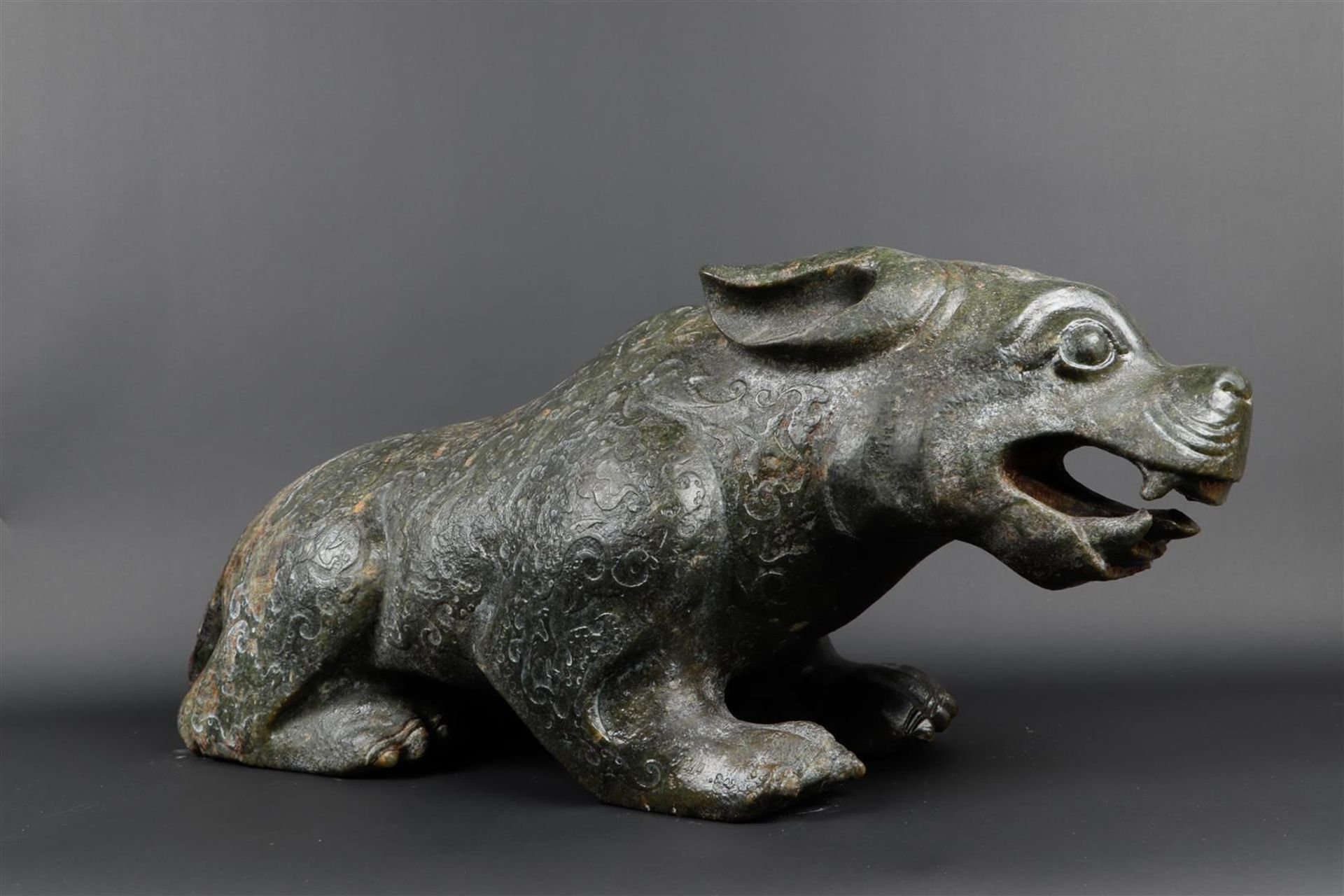 A "Spinach" jade sculpture of a fantasy lion. 20th century. Weight 34.5 kg.