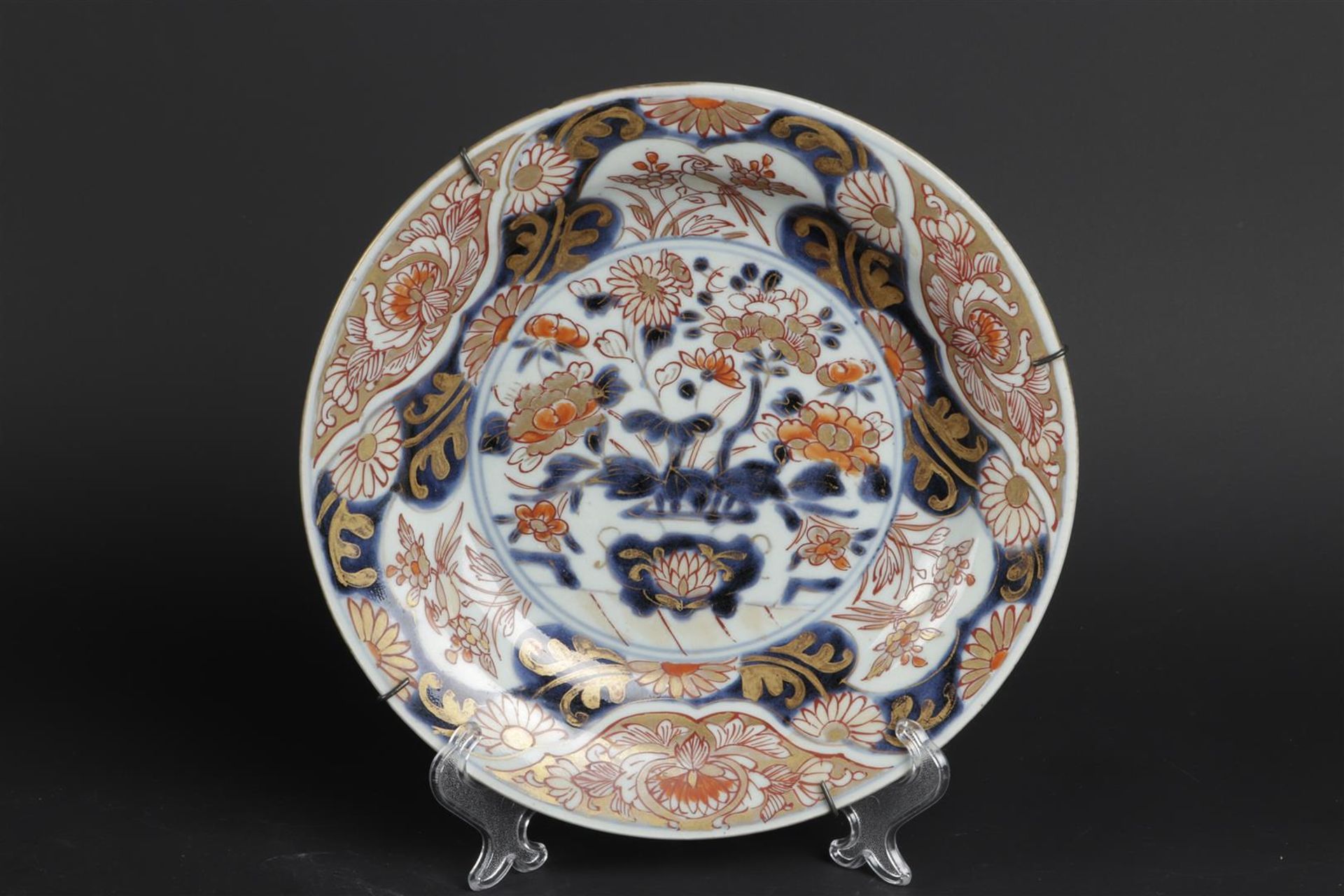 A porcelain Imari plate with a handle basket decor and a border outside. Japanese, early 18th centur