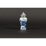 A porcelain baluster-shaped lidded vase with a mountain landscape decoration. China, Qianglong.