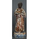 A carving of an African cleric with the infant Jesus. Remains of polychrome. Approx. 1900.