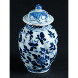 A porcelain twisted lid vase with floral decoration. China, Kangxi/Yongzheng.