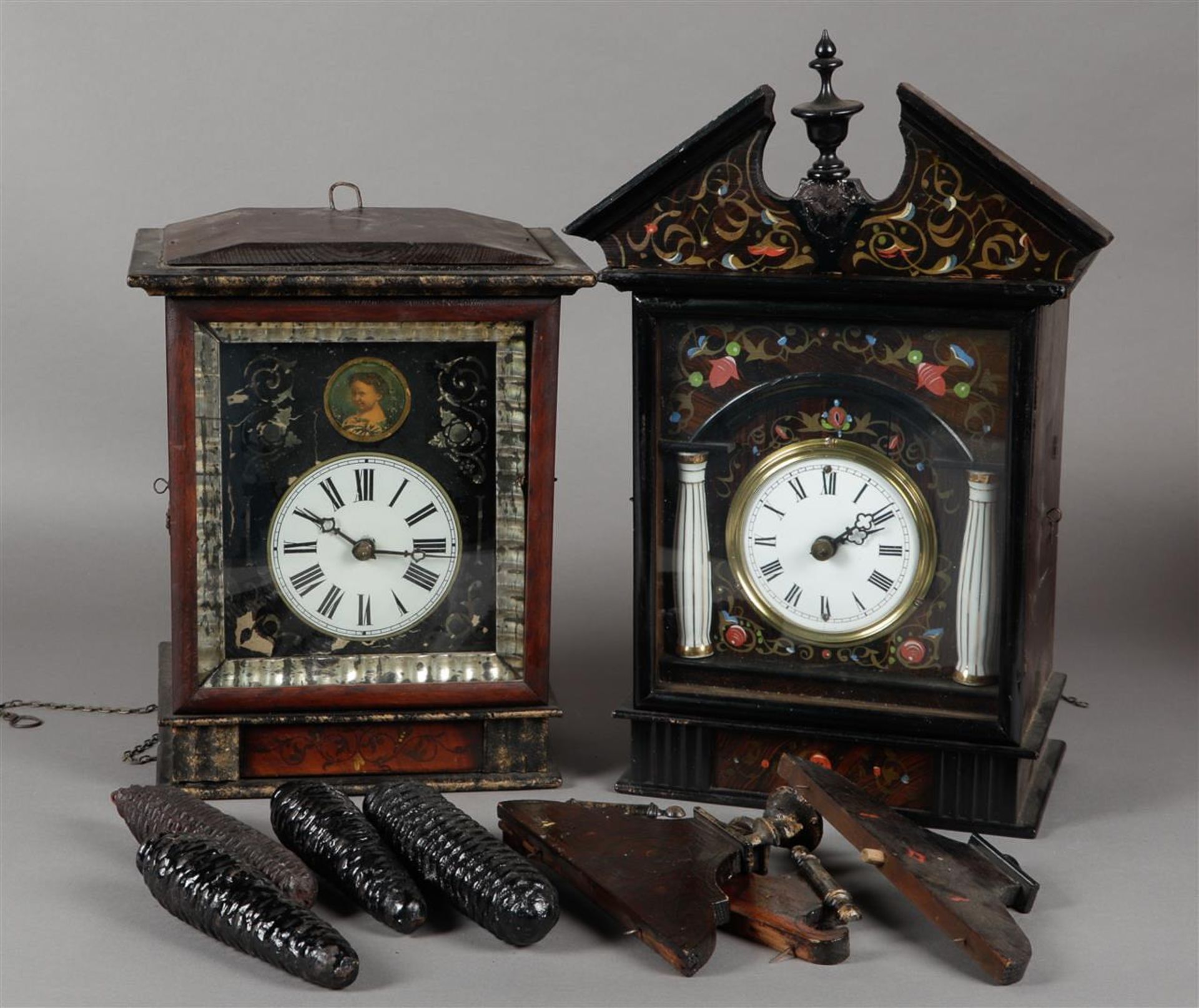 A lot of two Schwarzwalder wall clocks. Late 19th century. (Not tested for long-lasting effect).