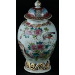 A porcelain Famille Rose vase with lid, decorated with flowers and birds. China, 18th century.