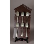 A wooden spoon rack with pewter spoons. 19th century.