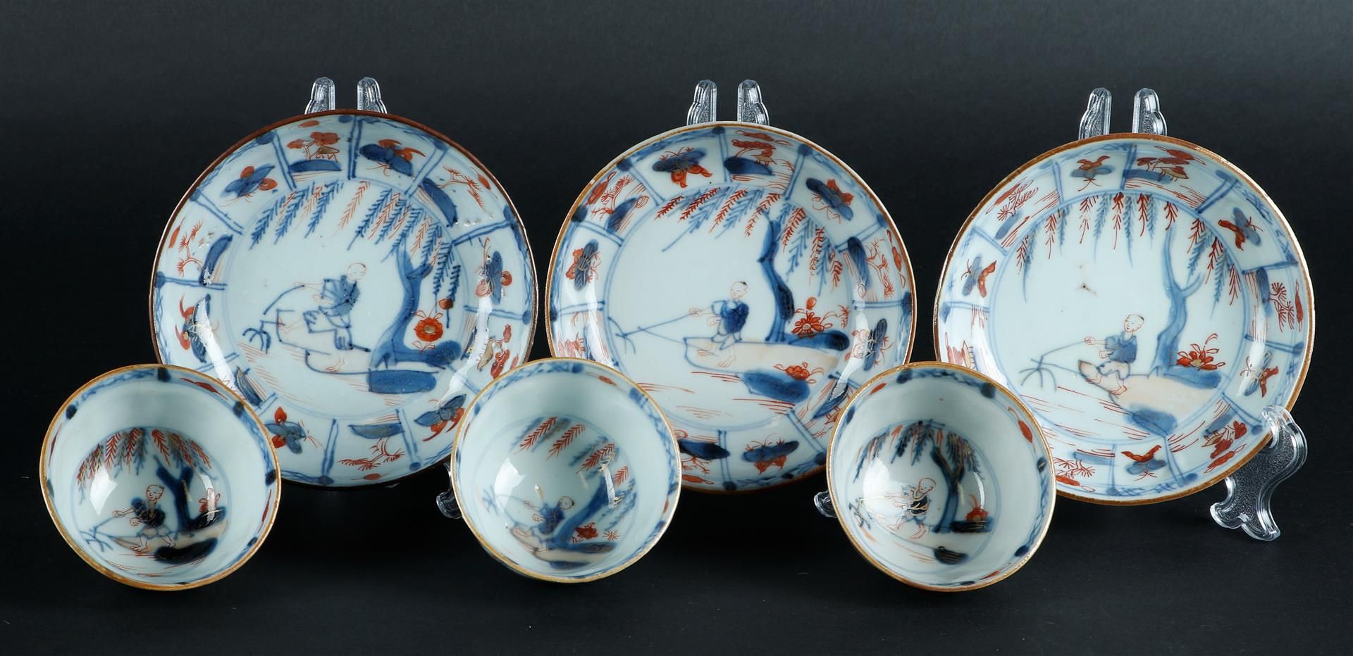 Three porcelain Imari cups and saucers with butterfly decor and floral decor, center with fisherman  - Image 3 of 4
