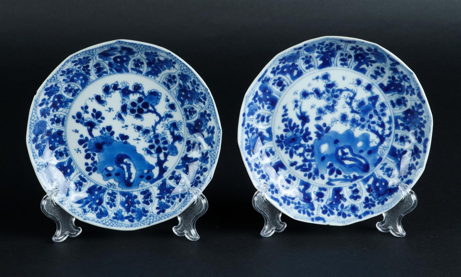 Two porcelain angled plates with relief lotus leaf, outer edge decor, the center with rich floral de