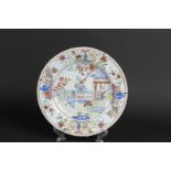 A porcelain Famille Rose plate with decoration of a pavilion with fence decor with flower vases and